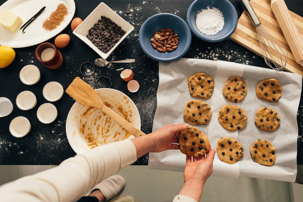 Beautiful woman Preparing Cookies And Muffins.